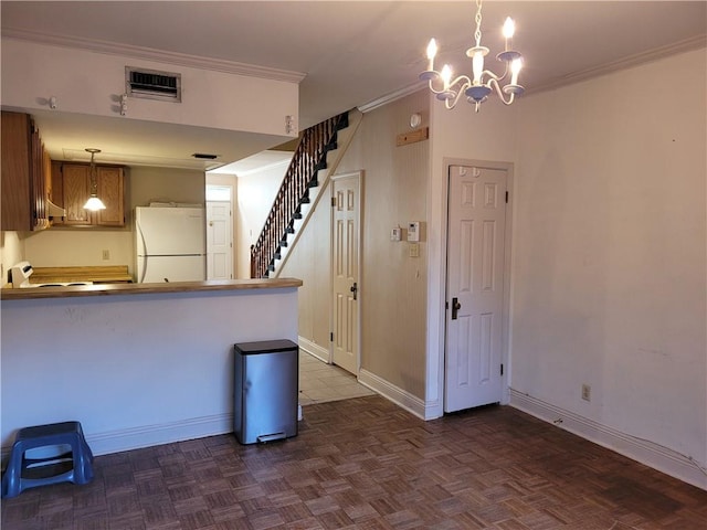 kitchen featuring an inviting chandelier, hanging light fixtures, dark parquet floors, white refrigerator, and kitchen peninsula