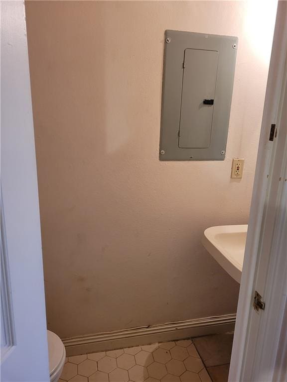 bathroom featuring toilet and tile floors