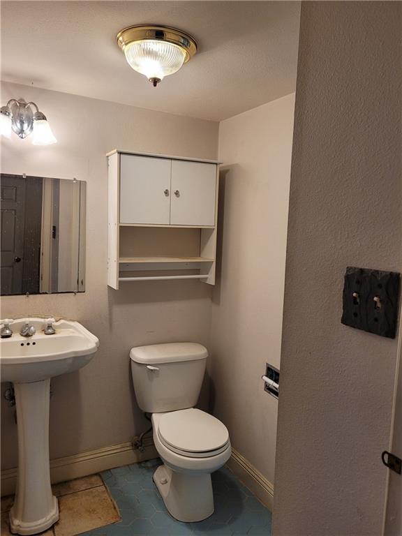 bathroom with tile floors and toilet