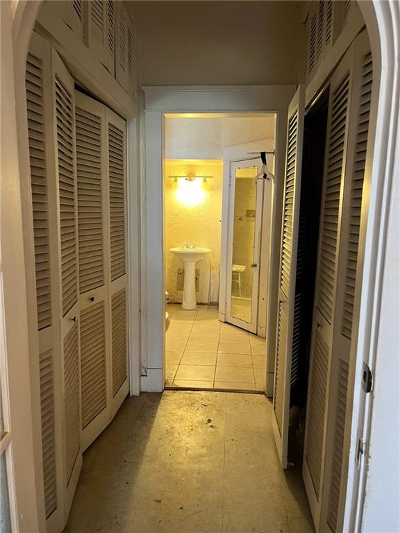 hallway featuring light tile floors