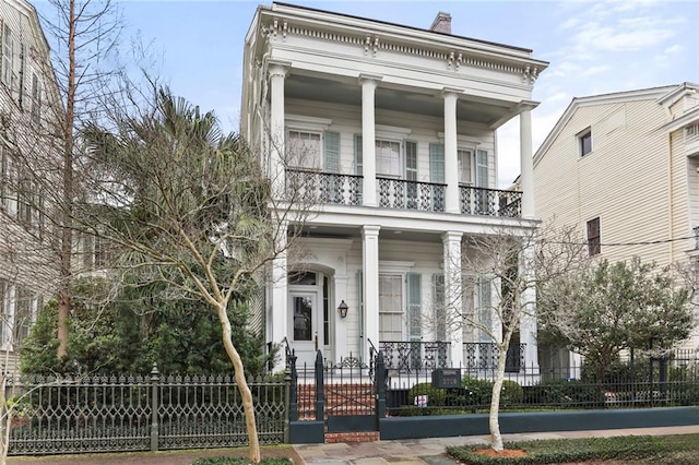 greek revival inspired property featuring a porch