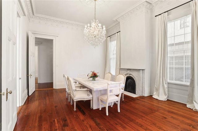 dining space with crown molding, dark wood-type flooring, and a chandelier