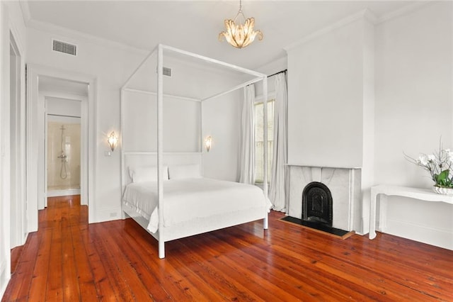 unfurnished bedroom with crown molding, dark hardwood / wood-style floors, and a chandelier