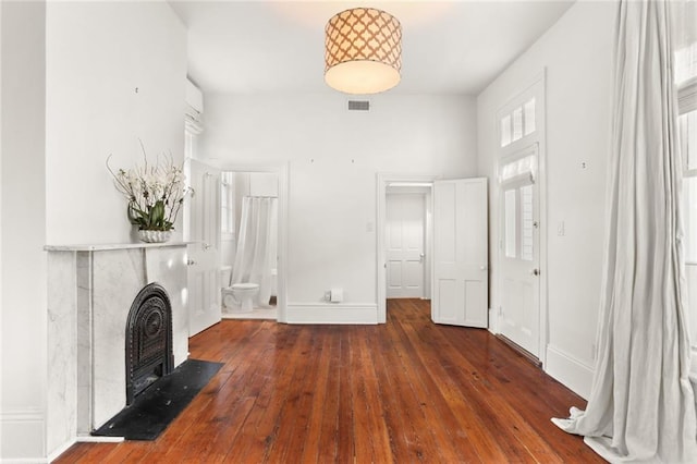 unfurnished living room featuring dark hardwood / wood-style floors