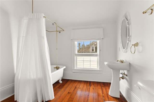 bathroom with toilet and hardwood / wood-style flooring