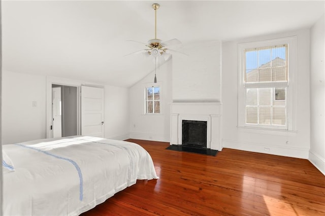 bedroom featuring dark hardwood / wood-style floors, ceiling fan, and vaulted ceiling