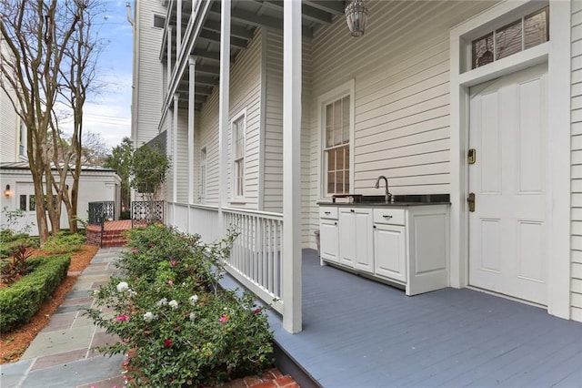 view of terrace with a porch and sink