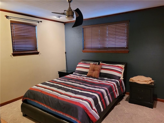 carpeted bedroom with ceiling fan and crown molding