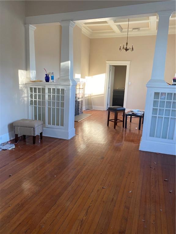 161214 N Broad St, New Orleans, LA 70119 - interior space with a chandelier, beamed ceiling, coffered ceiling, decorative columns, and dark wood-type flooring