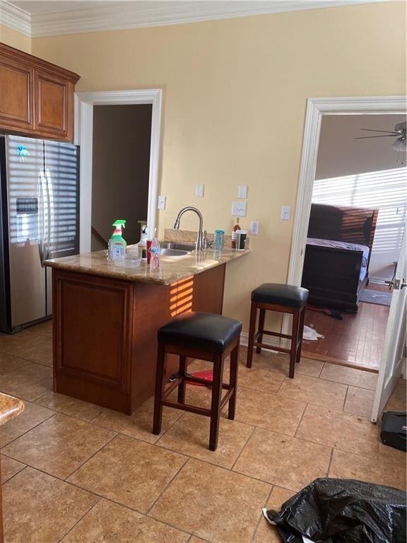 161214 N Broad St, New Orleans, LA 70119 - kitchen with kitchen peninsula, ceiling fan, crown molding, stainless steel refrigerator, and a wealth of natural light