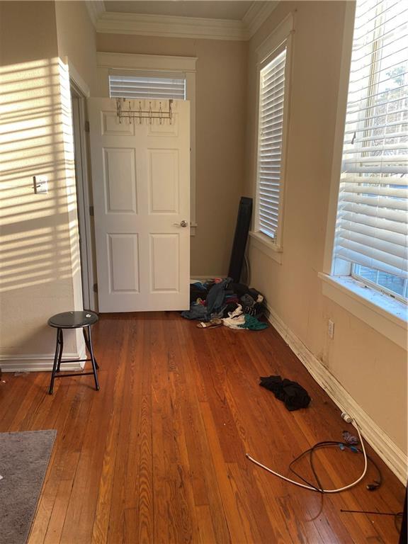 161214 N Broad St, New Orleans, LA 70119 - interior space featuring dark hardwood / wood-style flooring, crown molding, and plenty of natural light