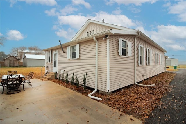 view of property exterior featuring a patio area