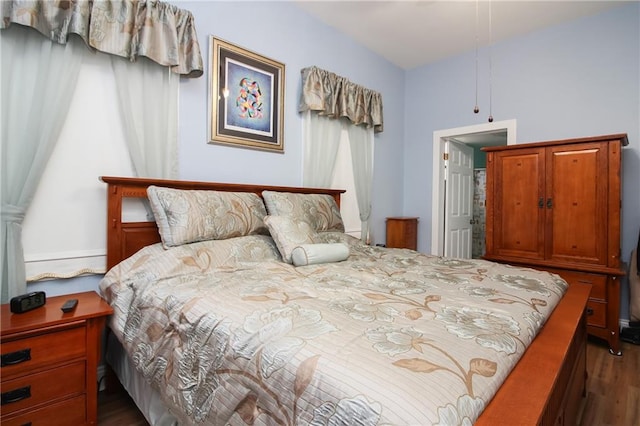 bedroom with dark wood-type flooring