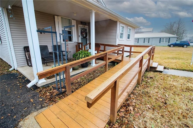 wooden deck featuring a lawn