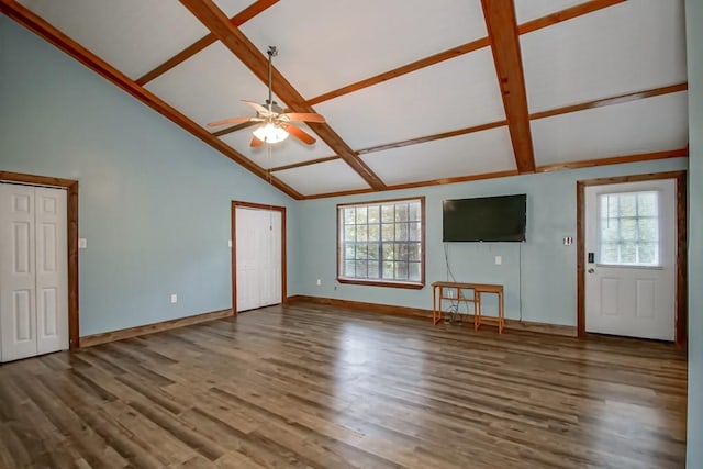 unfurnished living room featuring plenty of natural light, vaulted ceiling, and hardwood / wood-style floors