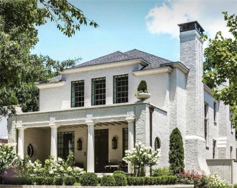 66 Thunderbird Dr, Covington, LA 70433 - view of front of property featuring a chimney, brick siding, and covered porch