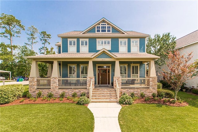 craftsman-style home with covered porch and a front lawn