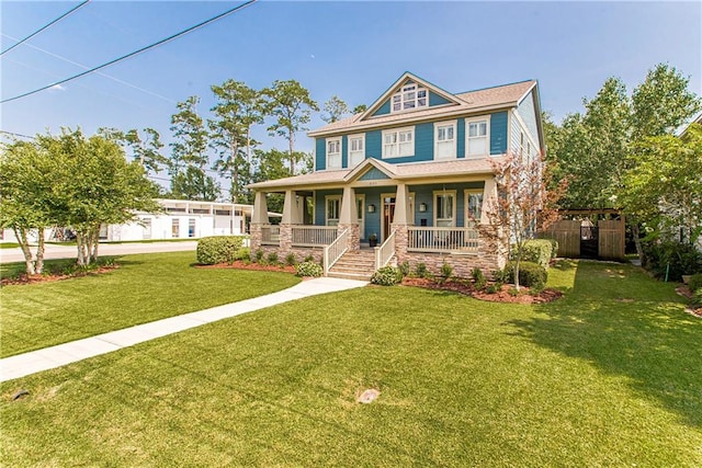 craftsman-style home with covered porch and a front yard