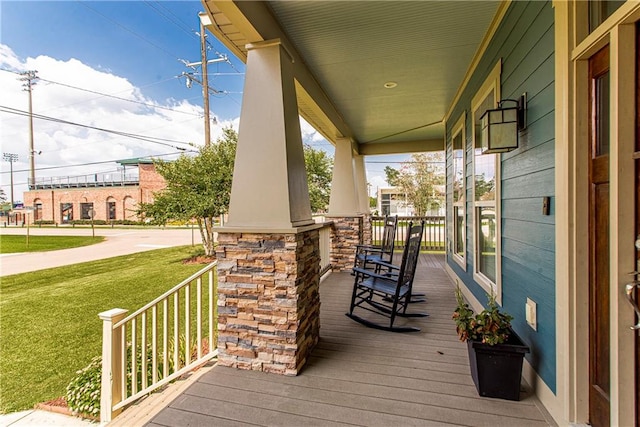 wooden deck featuring a yard