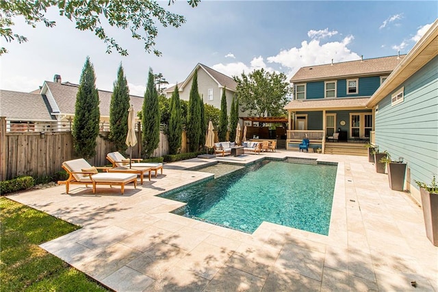 view of pool with outdoor lounge area and a patio