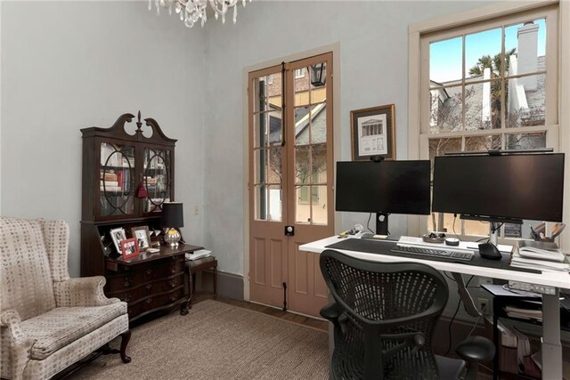 office featuring a notable chandelier and dark wood-type flooring