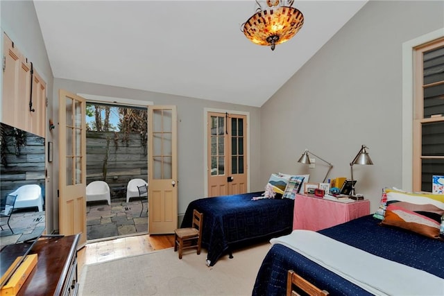 bedroom featuring french doors, wood-type flooring, and vaulted ceiling