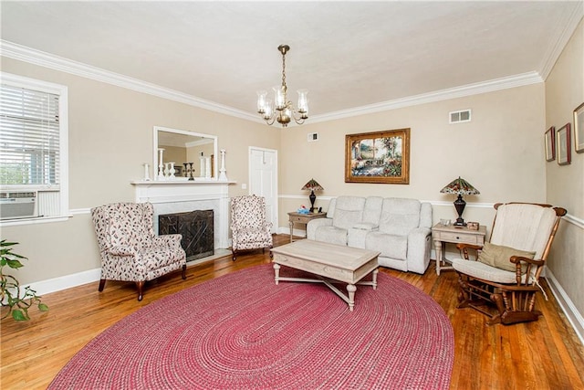 living room featuring cooling unit, a chandelier, hardwood / wood-style floors, and crown molding