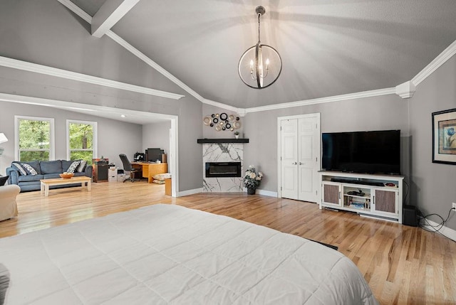 bedroom featuring light hardwood / wood-style flooring, a premium fireplace, and crown molding