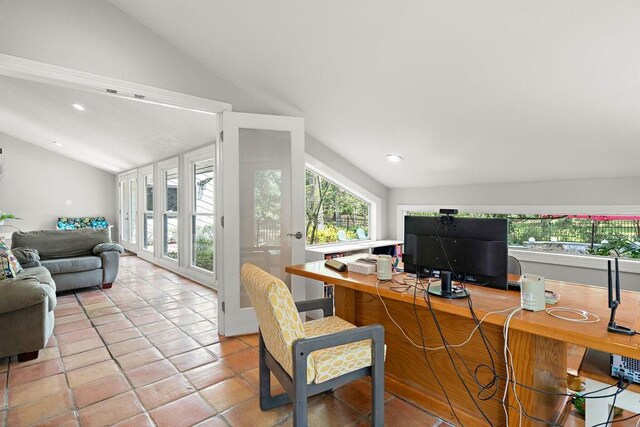 office area with light tile patterned flooring and lofted ceiling