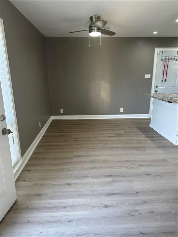 empty room featuring ceiling fan and light hardwood / wood-style floors