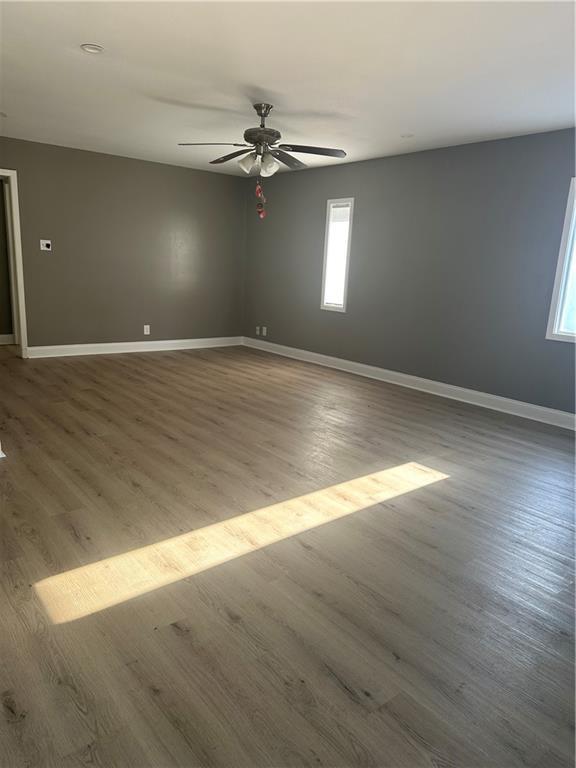 spare room featuring hardwood / wood-style flooring and ceiling fan