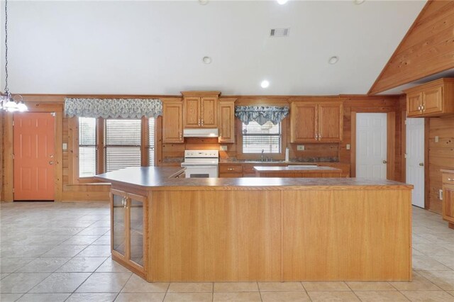 kitchen featuring decorative light fixtures, electric stove, vaulted ceiling, a kitchen island, and light tile patterned floors