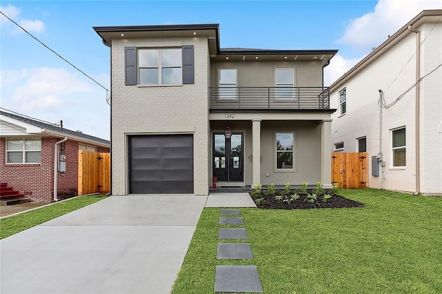 view of front facade with a balcony, a front lawn, and a garage