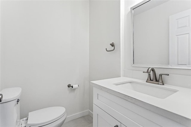 bathroom with tile patterned floors, vanity, and toilet