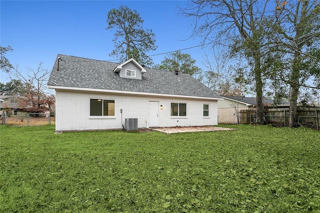 back of property featuring a lawn and central AC