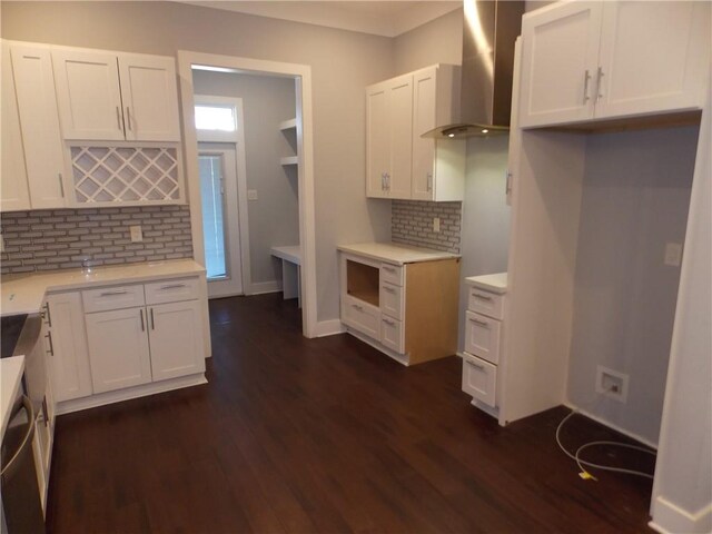 kitchen featuring white cabinetry, wall chimney exhaust hood, tasteful backsplash, and dark hardwood / wood-style floors