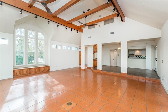 interior space featuring ceiling fan, light tile floors, high vaulted ceiling, and beam ceiling