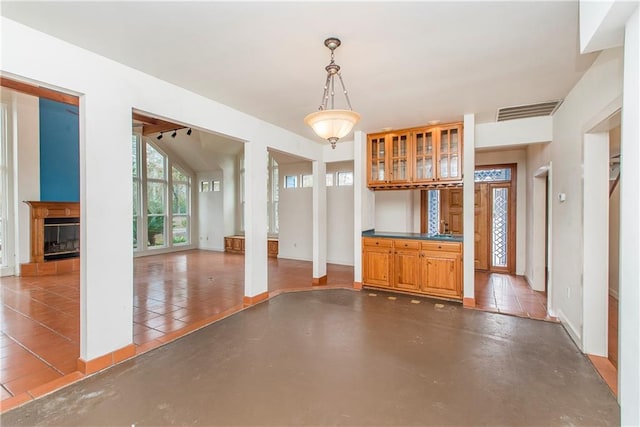 unfurnished living room featuring vaulted ceiling and tile floors