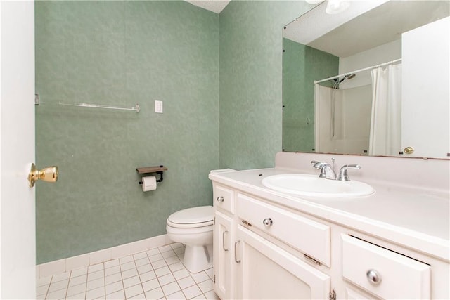 bathroom with tile flooring, large vanity, and toilet