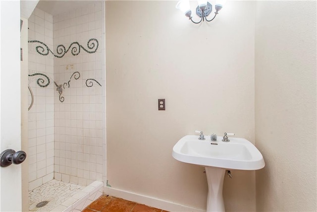 bathroom featuring tile flooring and tiled shower