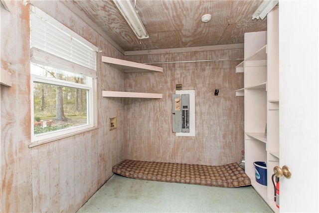 clothes washing area with hookup for a washing machine and wood walls