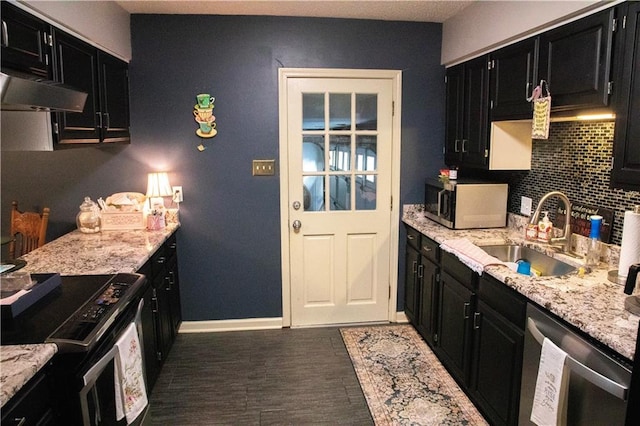 kitchen featuring sink, tasteful backsplash, light stone counters, and electric stove