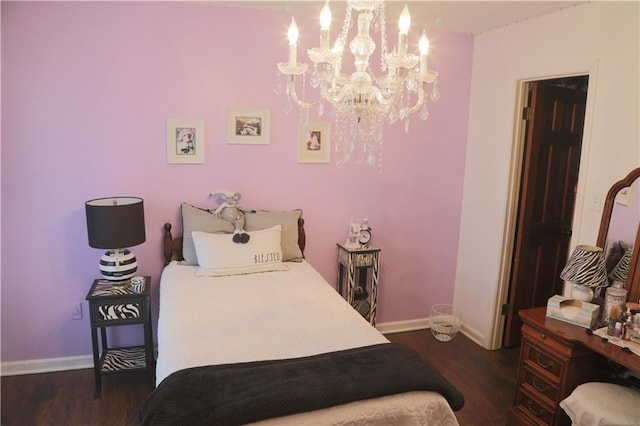 bedroom with dark hardwood / wood-style flooring and a chandelier