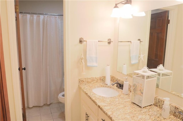 bathroom featuring tile floors, toilet, and vanity