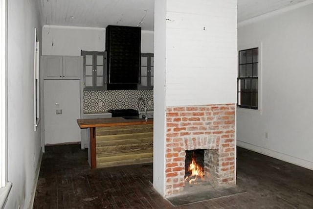 interior space featuring dark hardwood / wood-style floors, a fireplace, and sink