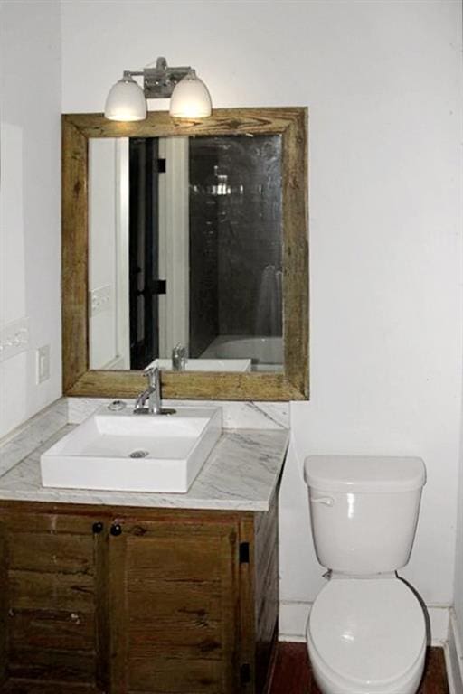 bathroom with toilet and vanity