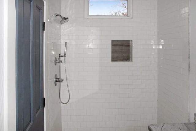 bathroom with a tile shower