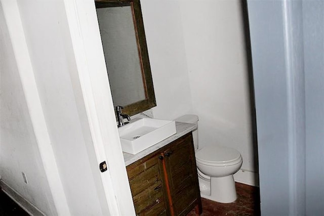 bathroom featuring tile flooring, toilet, and vanity