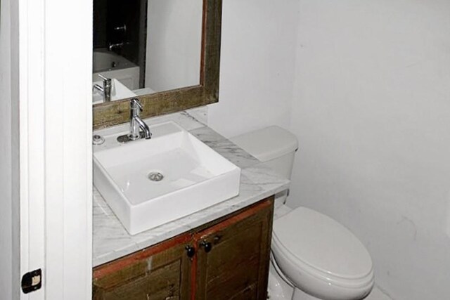 bathroom with oversized vanity and toilet