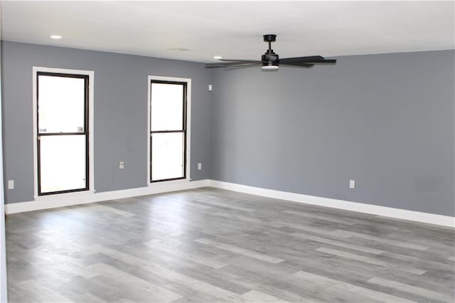 spare room with ceiling fan and light hardwood / wood-style floors